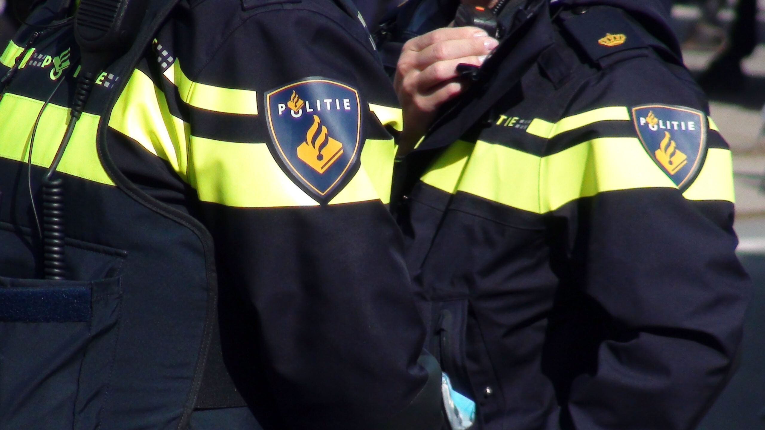 Dutch Local Police Officers In Police Uniform Standing On The Street Of